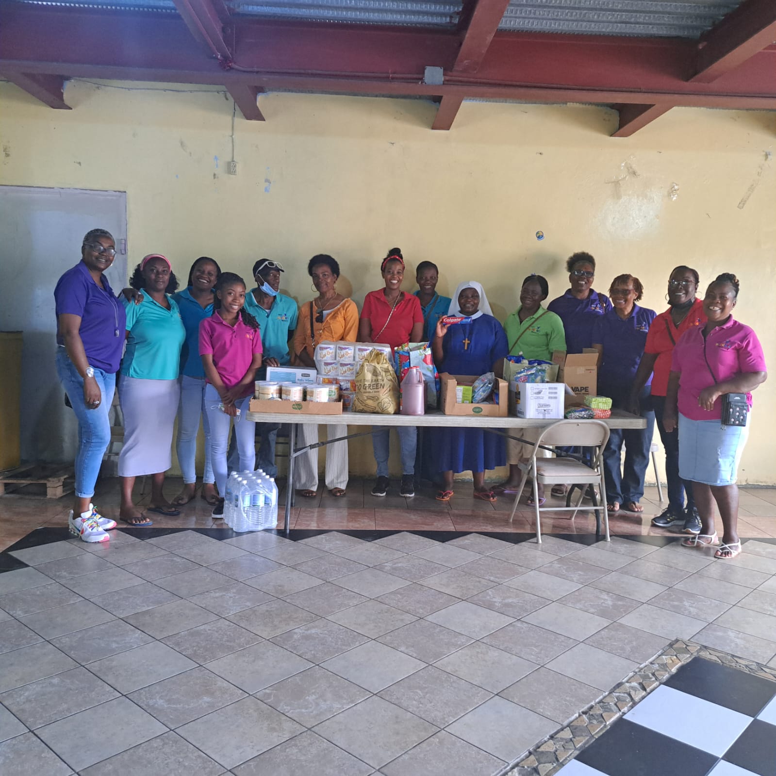 Childcare Ministry team presenting donated food and care supplies