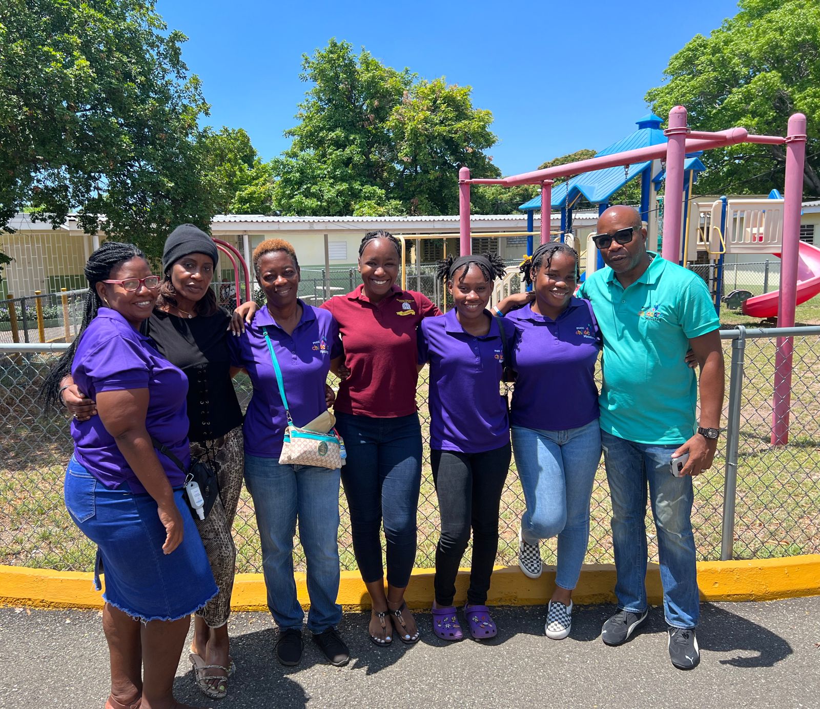 Childcare Ministry volunteers gathered near a children's playground