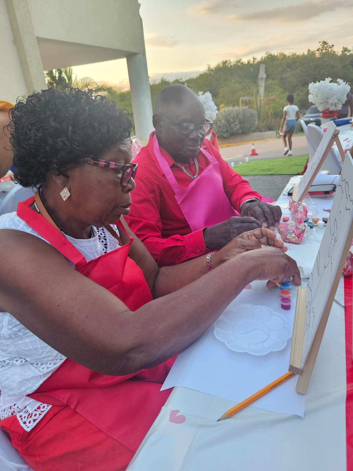 A couple working side by side on their paintings