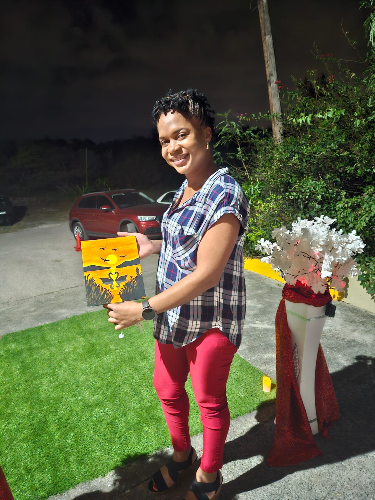 A participant presenting a sunset painting from the couples' activity