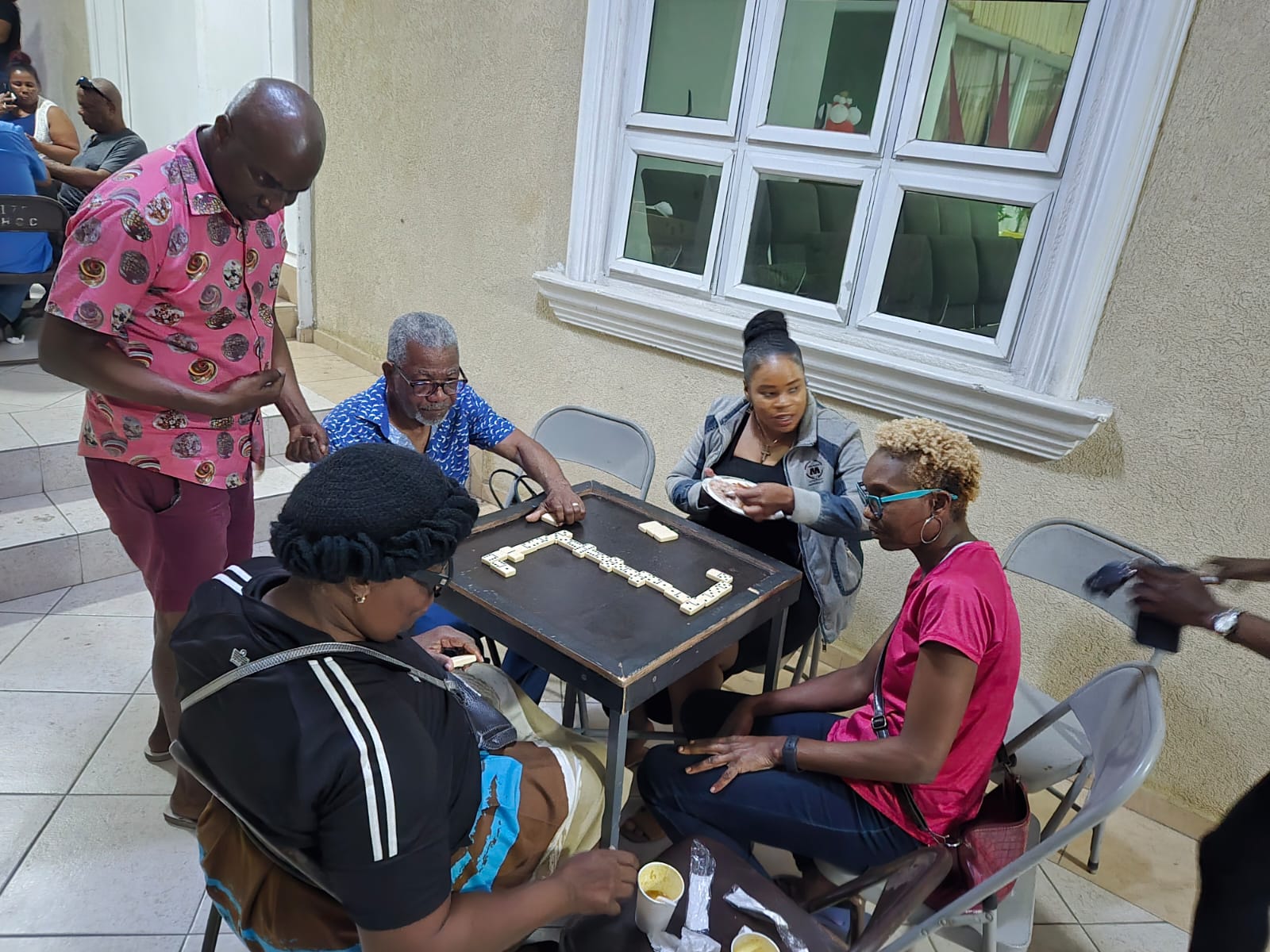 Ministry members enjoying dominoes together at a community gathering