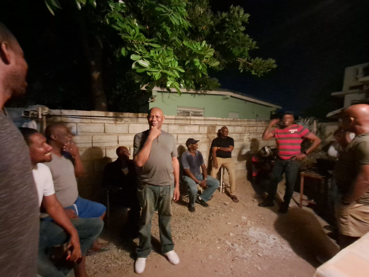 Men sharing stories and laughter at an evening fellowship