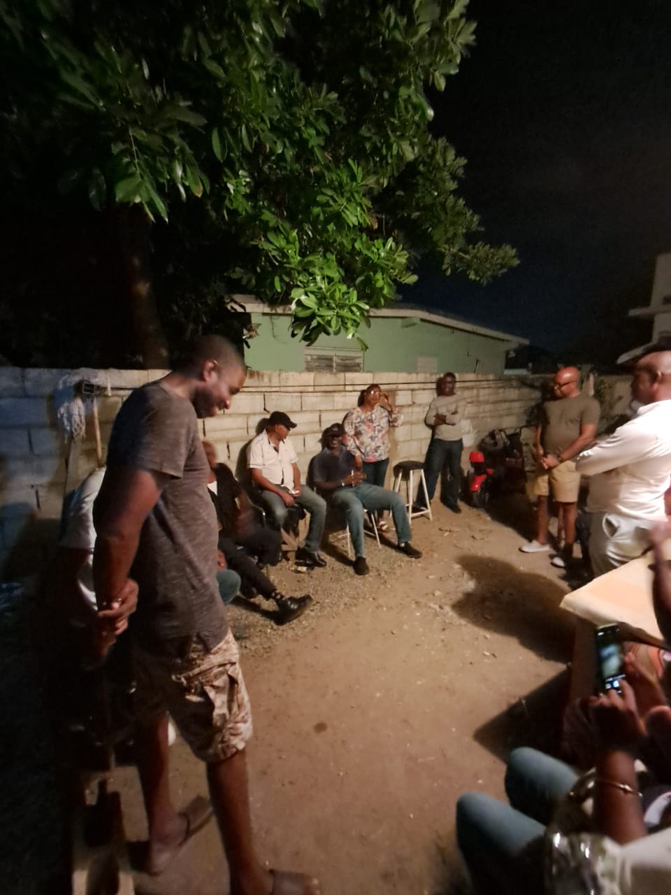 Men gathered in prayer during an evening fellowship