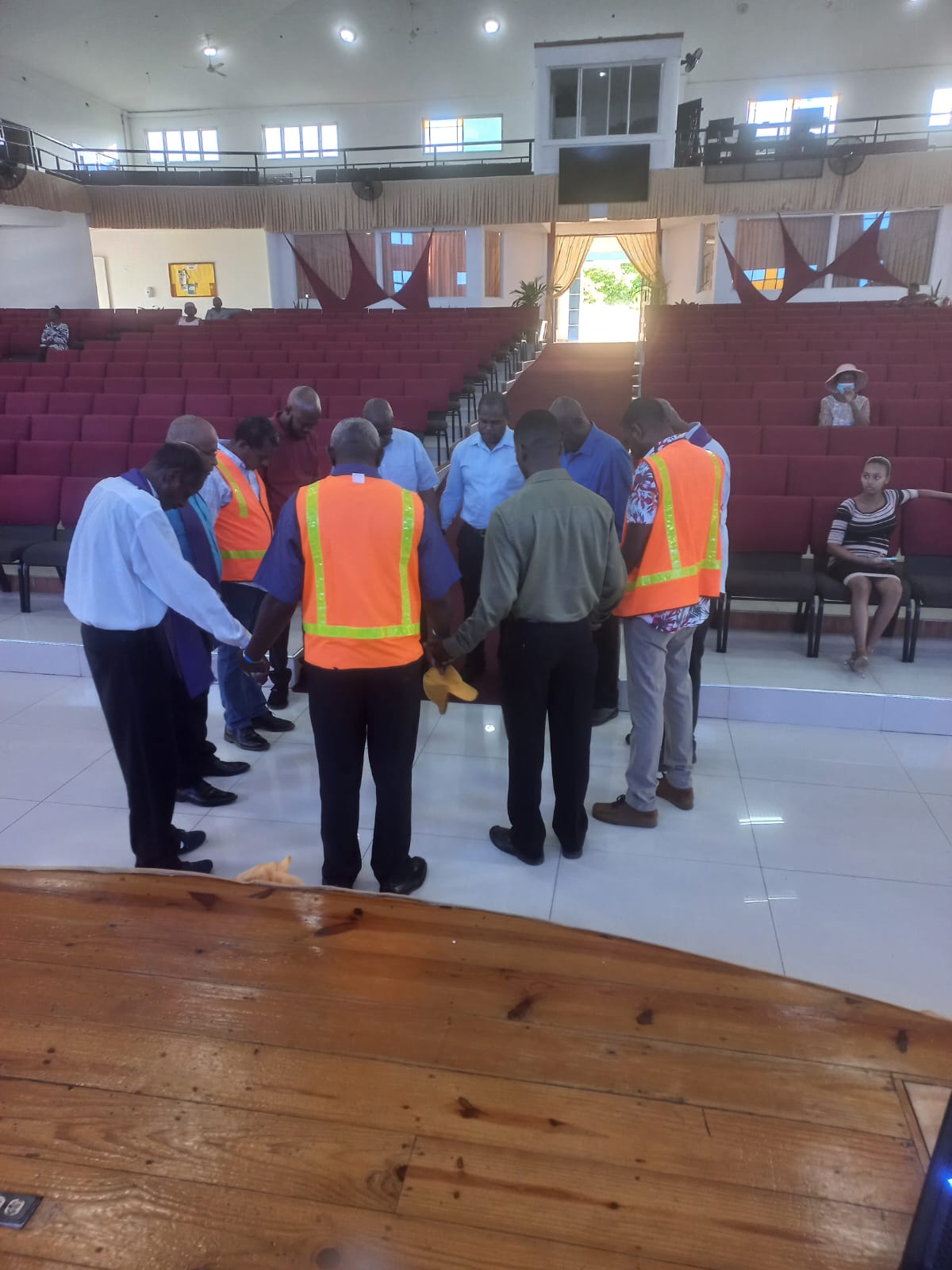 Men gathered in a wide prayer circle inside the sanctuary