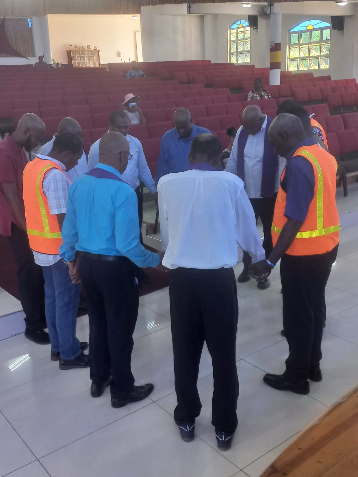 Men bowing their heads together in prayer
