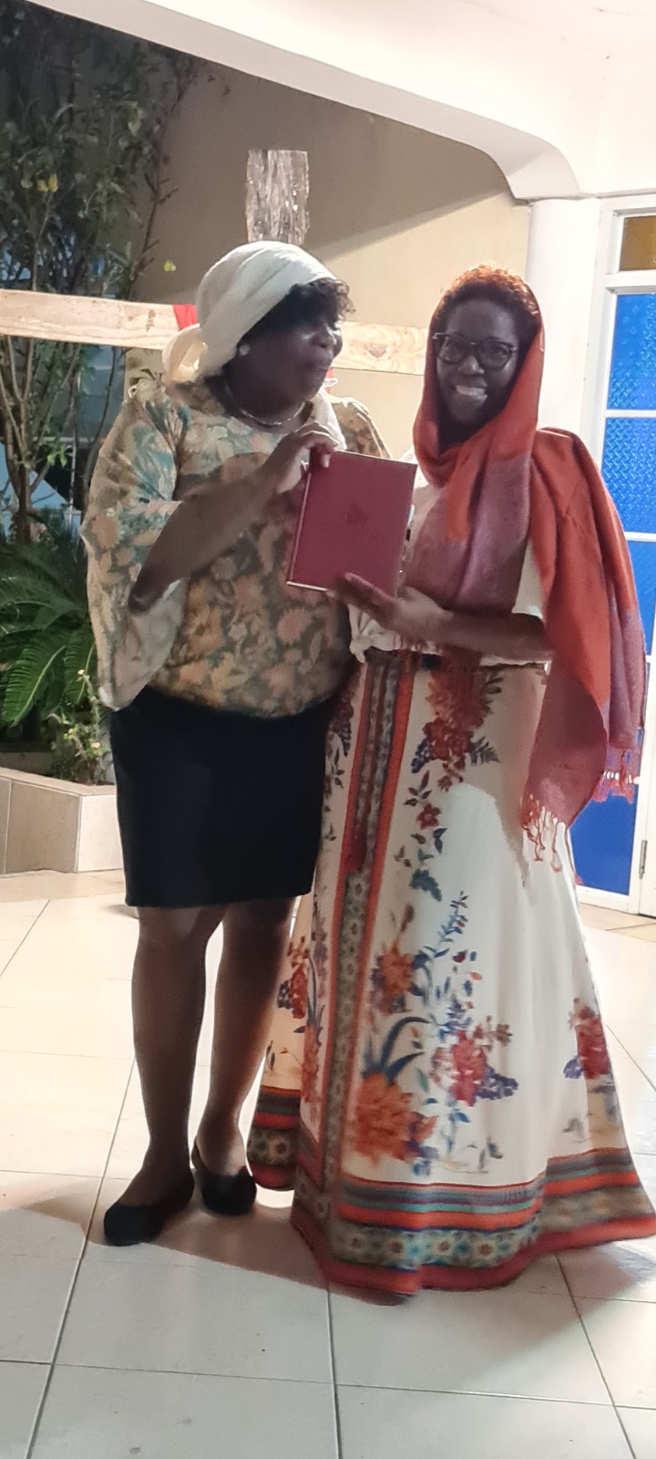 Two women taking part in a Christmas fellowship presentation
