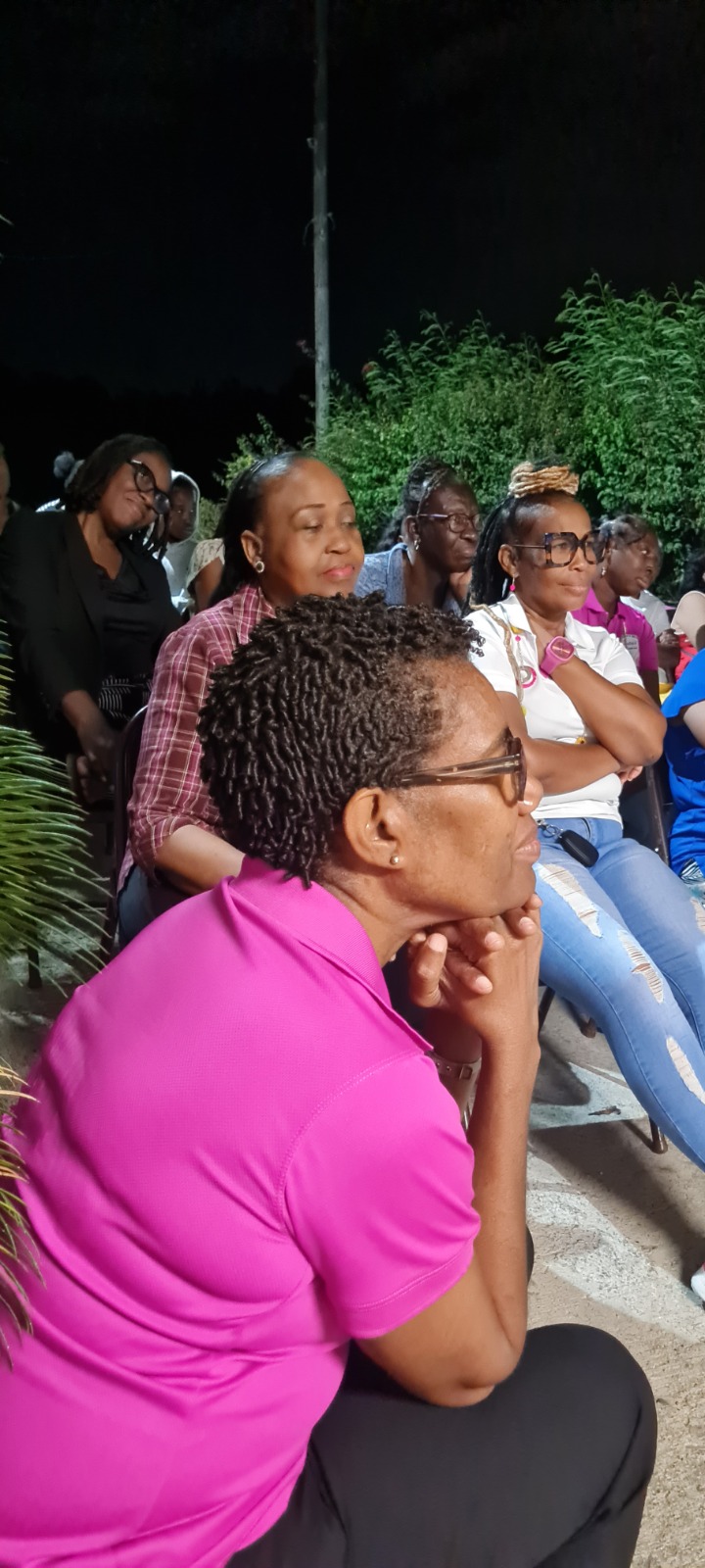 Women listening together during an outdoor fellowship gathering
